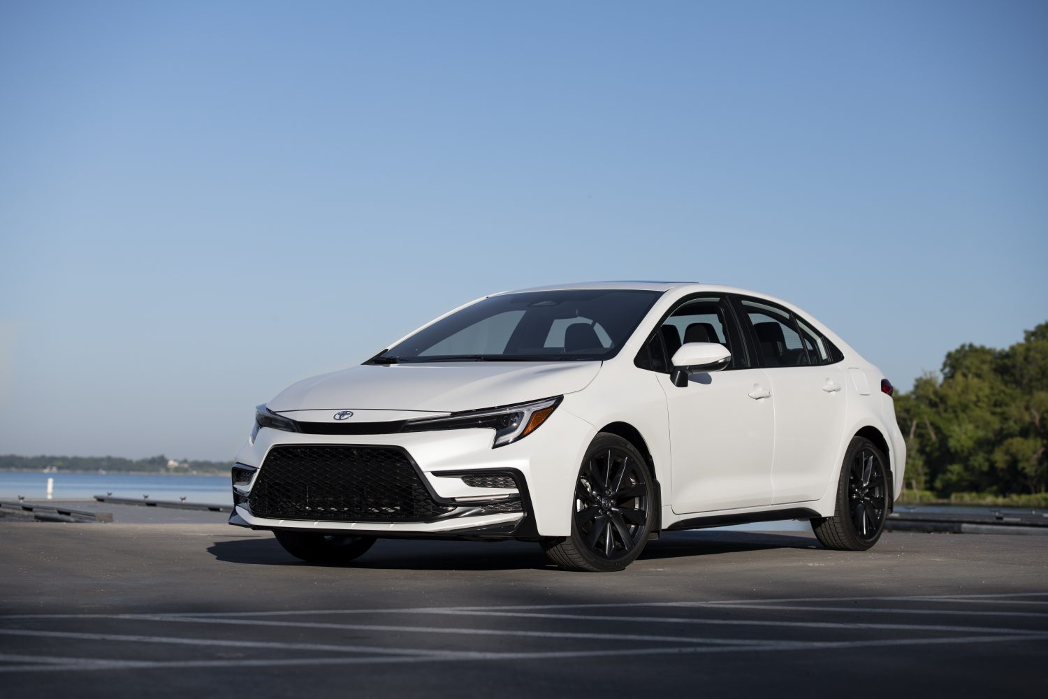 A white 2023 Toyota Corolla parked in left front angle view at a marina