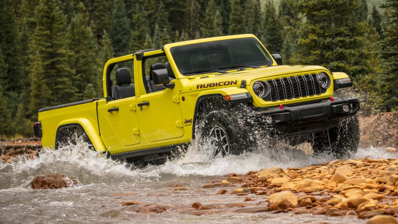 The 2024 Jeep Gladiator crossing through a river