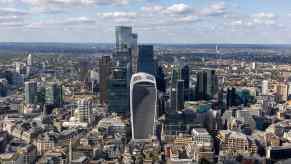 The skyline of the city of London on a sunny day, dominated by the walkie talkie building with its heat death ray.