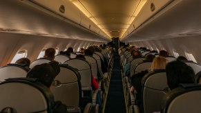 Passengers in the cabin of a jet airplane during an international flight.