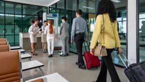 Passengers wait at a standstill line for airport security.