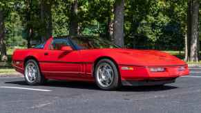 A 1990 Chevrolet Corvette ZR-1 in Bright Red parked outside in right front angle view