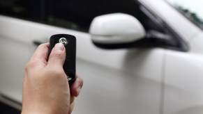 Person's hand holding a car key fob