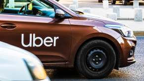Uber badge on car door in traffic in Romania