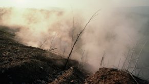 Smoke covers a mountainside as a coal fire burns beneath Centralia, Pennsylvania