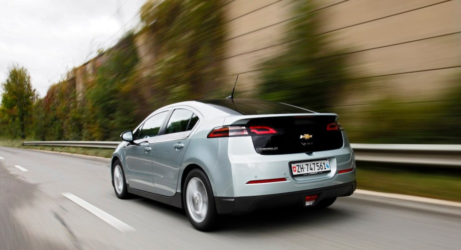 Silver Chevrolet Volt electric hybrid sedan driving on a highway.