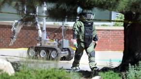 An officer responds to a bomb threat near a car park.