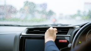 A driver inspects their vents after their car heater stopped working.