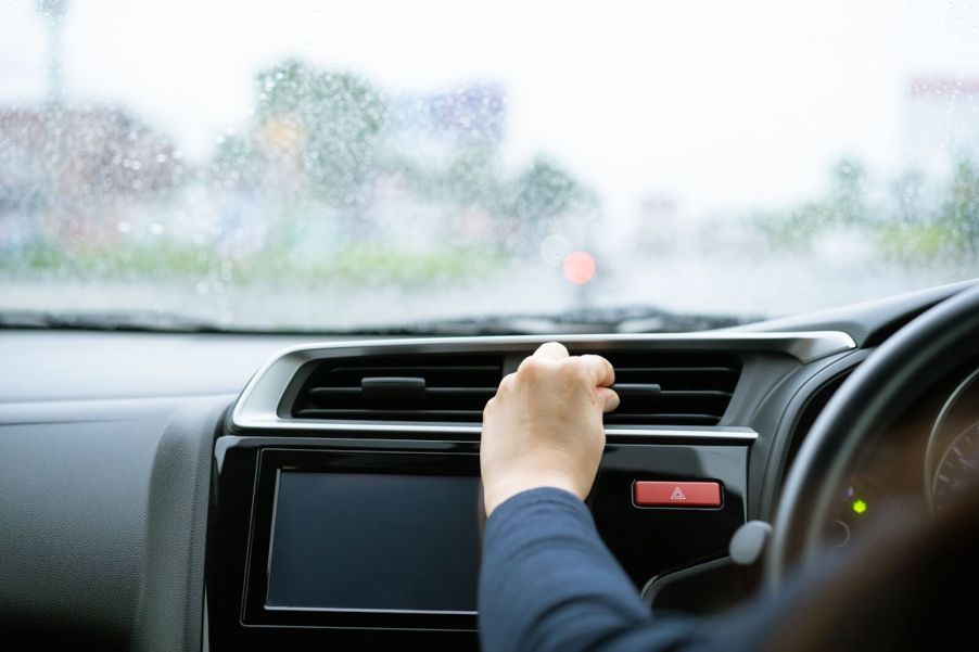 A driver inspects their vents after their car heater stopped working.