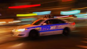 An NYPD police car rushes to arrest a drunk driver.