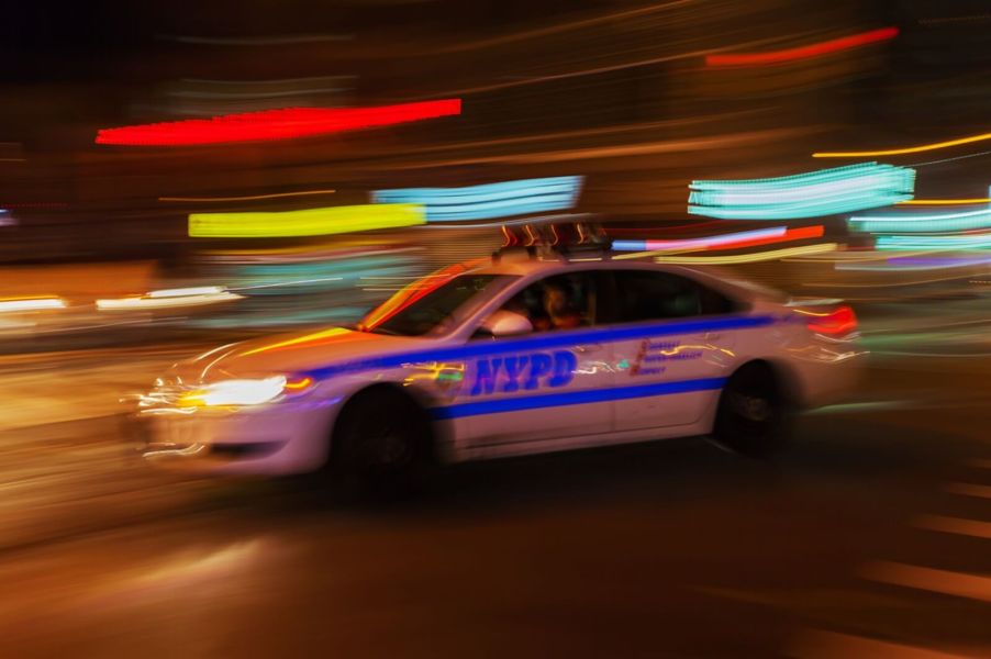 An NYPD police car rushes to arrest a drunk driver.