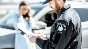 Police officer writes a ticket.