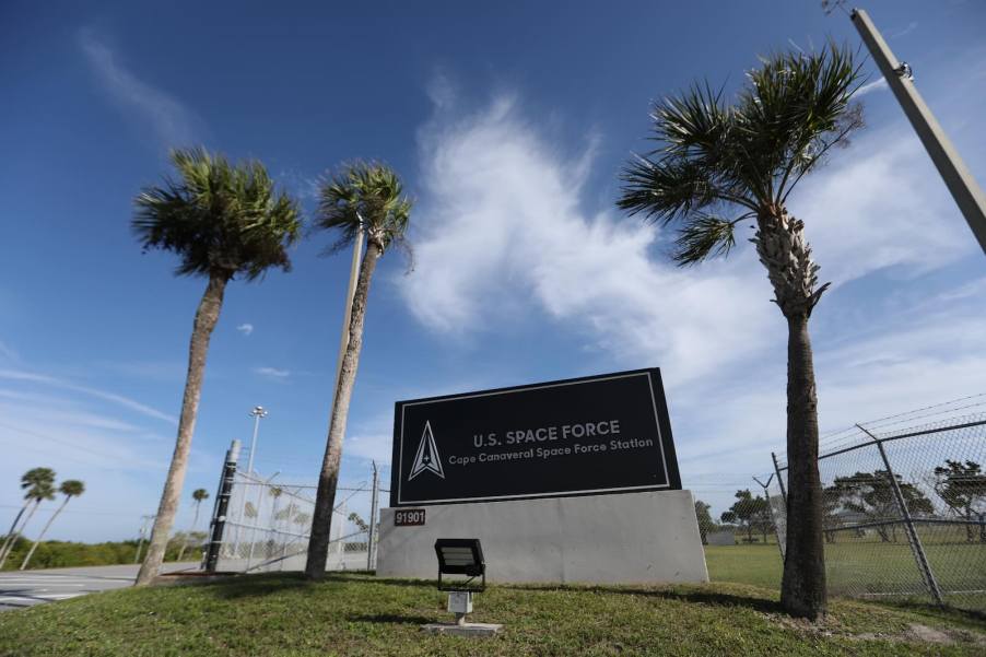 U.S. Space Force sign between palm trees, in front of a base.