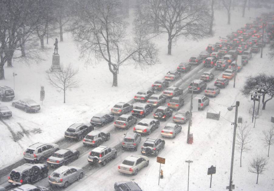 Overhead view of cars lined up on a snowy road during a traffic jam