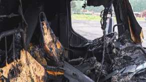 The charred cab of a truck after a bad fire.