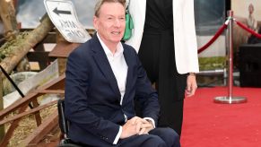 Frank Gardner dressed in a suit attending the European premier of the movie "Twisters" poses on the red carpet