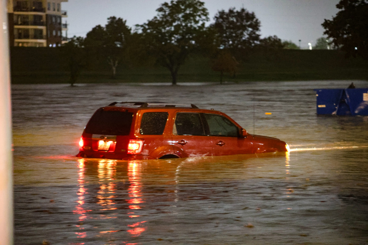 An SUV in deep flood waters 