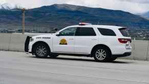 A white Utah Highway Patrol SUV cruiser parked on the highway