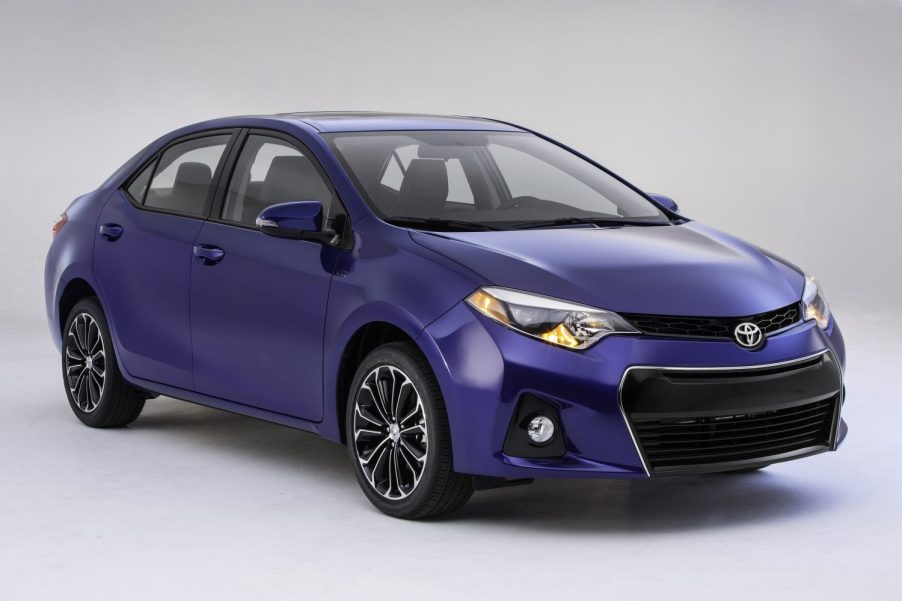A blue 2014-2016 Toyota Corolla parked in right front angle view in white space
