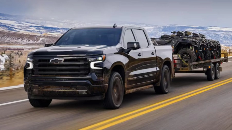 A 2024 Chevy Silverado 1500 towing ATVs
