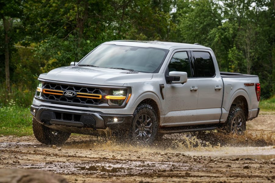 The 2024 Ford F-150 Hybrid splashing through mud