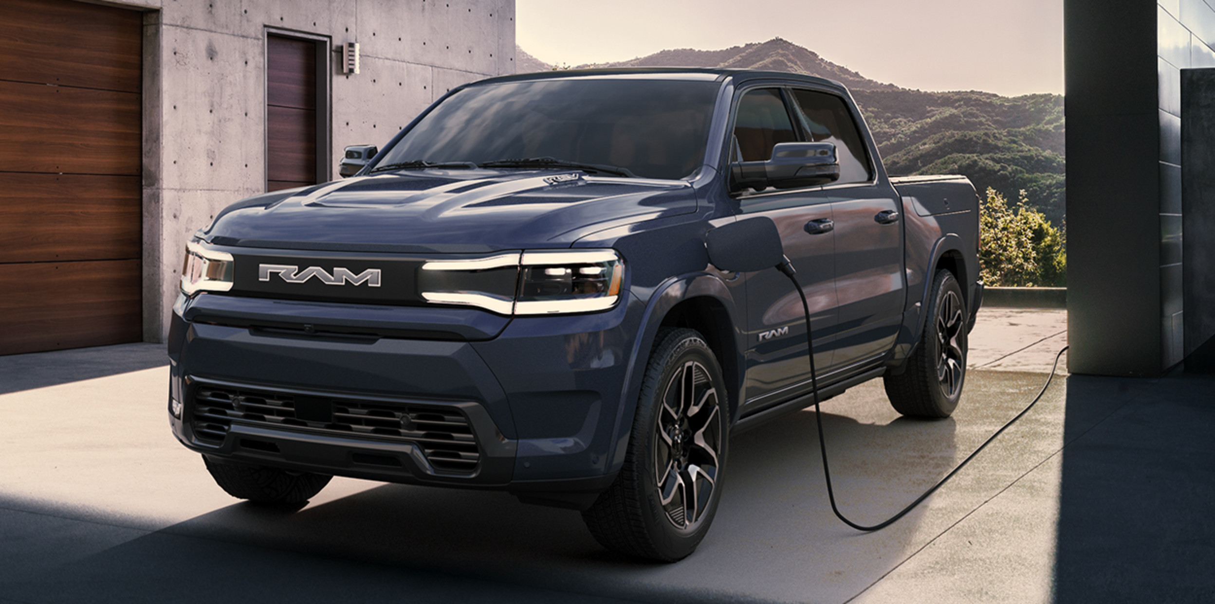 The 2025 Ram 1500 REV charging in a garage
