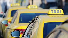 A taxi lineup waits for drunk passengers and travelers.