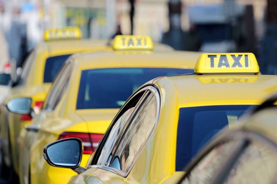A taxi lineup waits for drunk passengers and travelers.