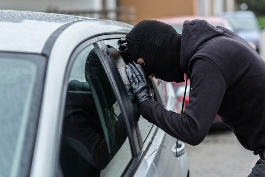 A car thief casing the latest of his stolen cars.