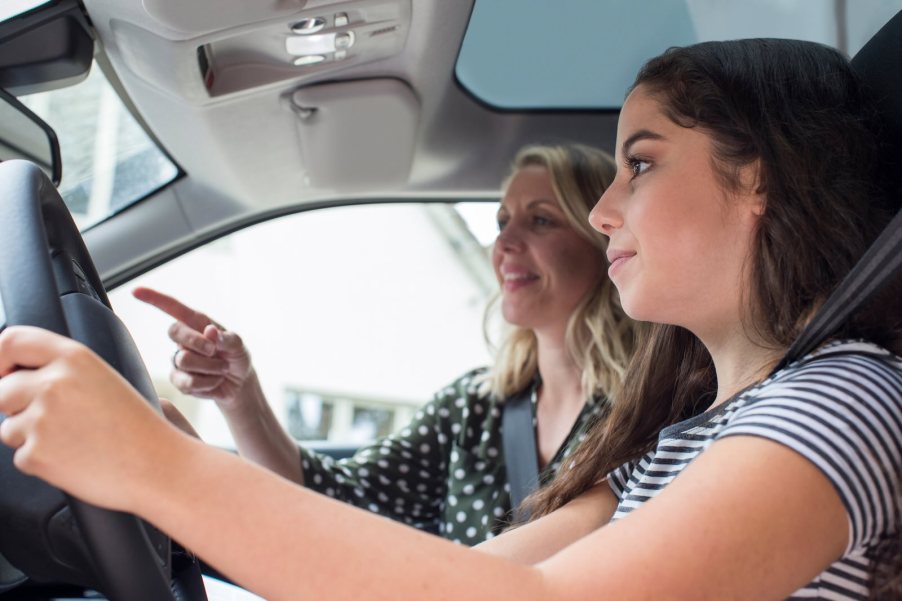 Driver's ed instructor pointing to order teenage driver to complete an errand