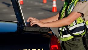 Police officer reading gps car tracker data on a laptop.