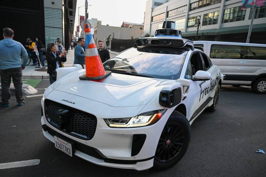 White self-driving Jaguar by Waymo parked in San Francisco street corner