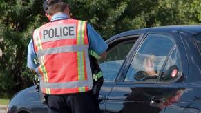 A police officer at a traffic stop during the daytime.