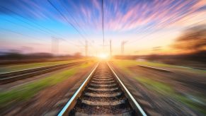 Train tracks with a train blurring by