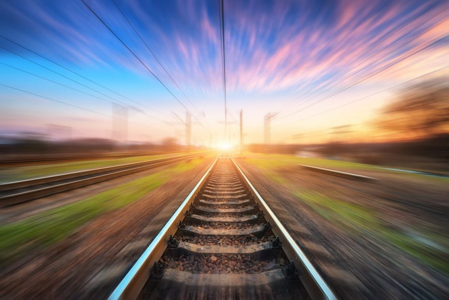 Train tracks with a train blurring by