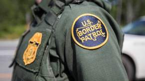 The U.S. Border Patrol patch on the arm of an agent during a highway checkpoint search.