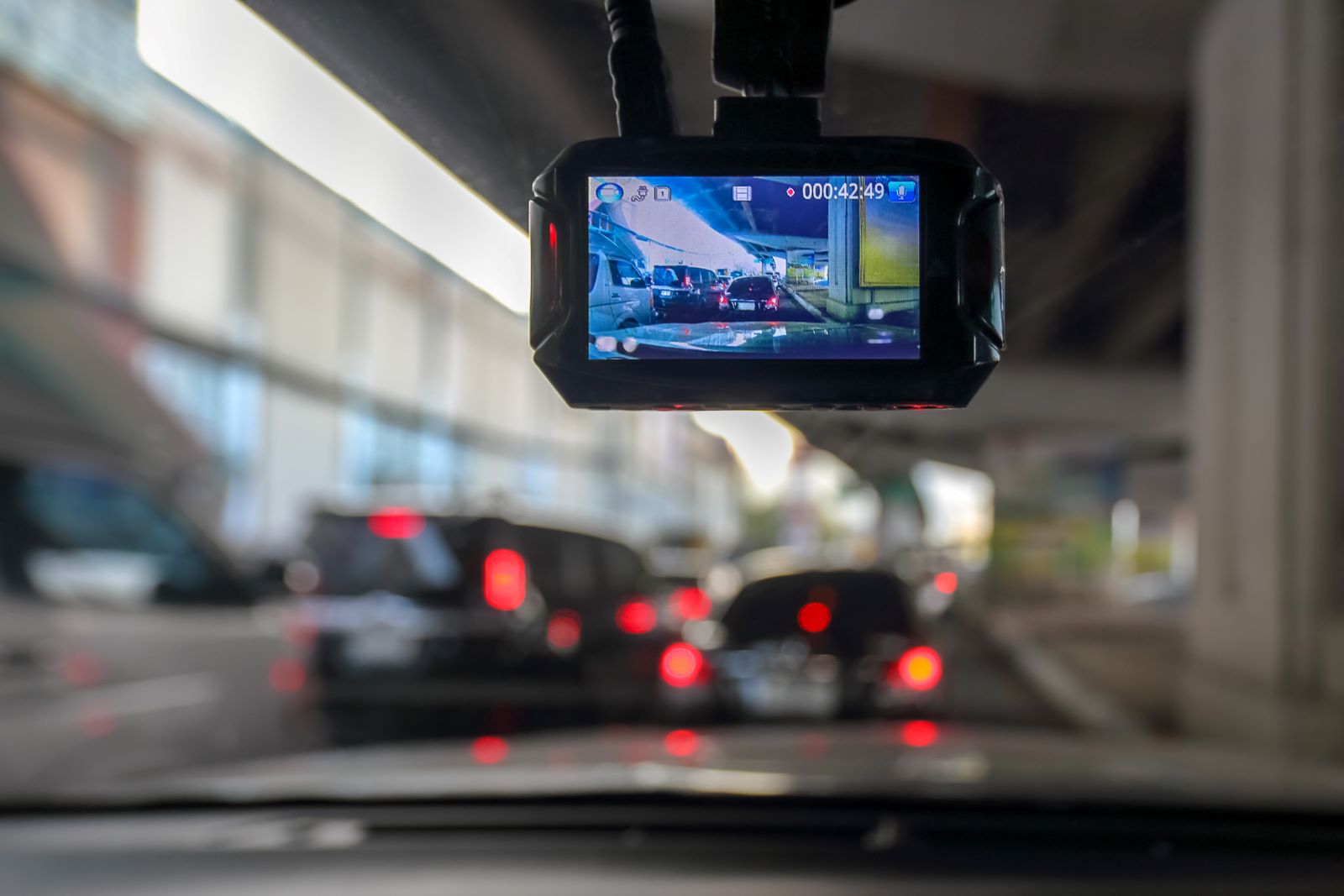A front facing camera shows the image of cars in front of it, recording
