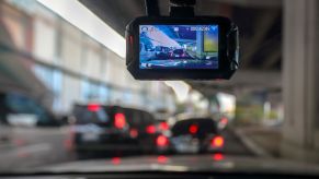 A front facing camera shows the image of cars in front of it, recording