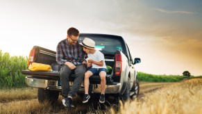 Father and son in the back of a truck