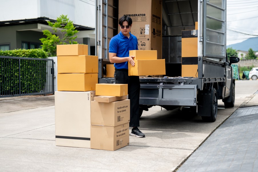 A man loading boxes into a moving truck