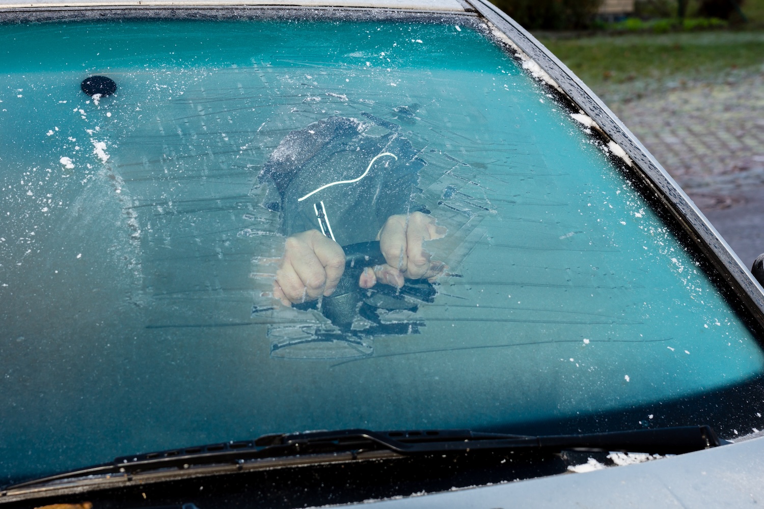 A man driving with ice on his windshield 