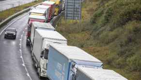 Semi trucks piled up on a highway, causing a traffic jam