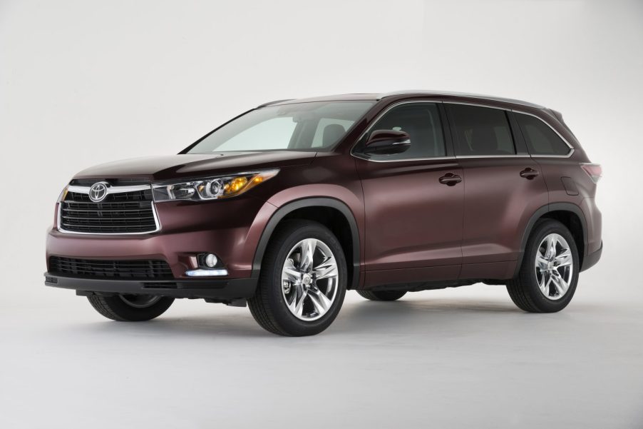 A deep purple colored 2014 Toyota Highlander SUV parked in left front angle view
