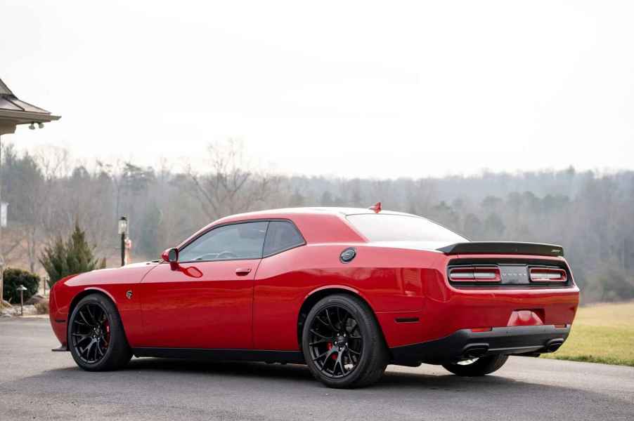 A red 2016 Dodge Challenger parked in left rear angle view