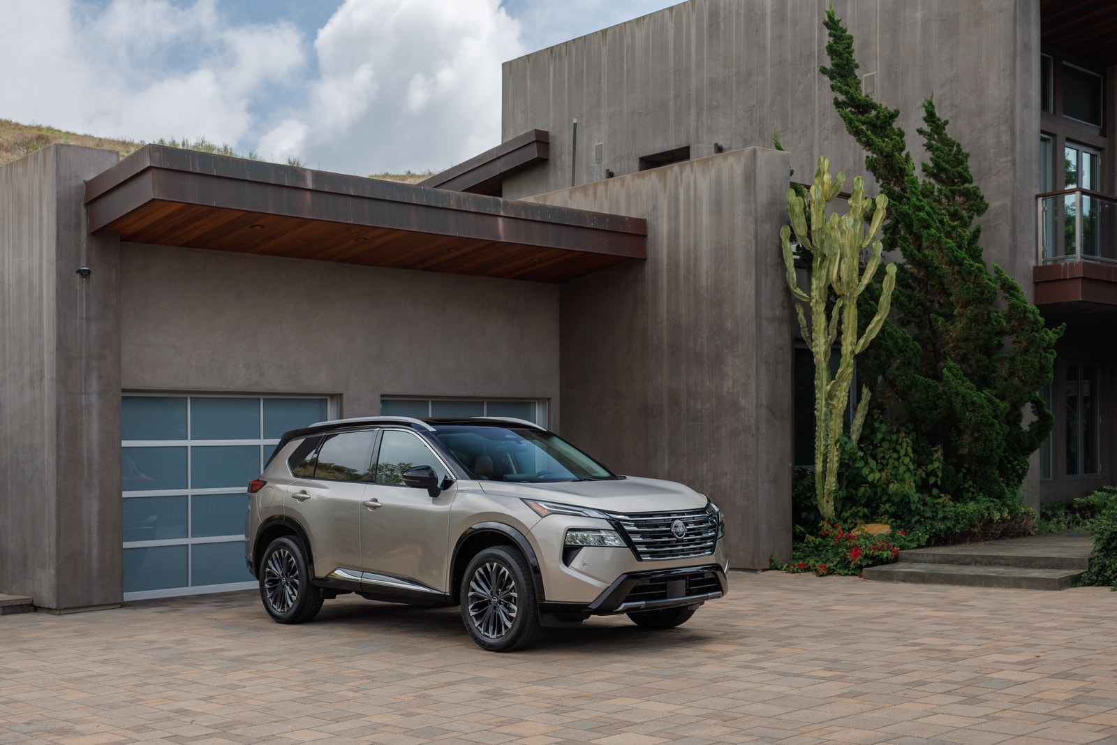 The 2024 Nissan Rogue parked near a home