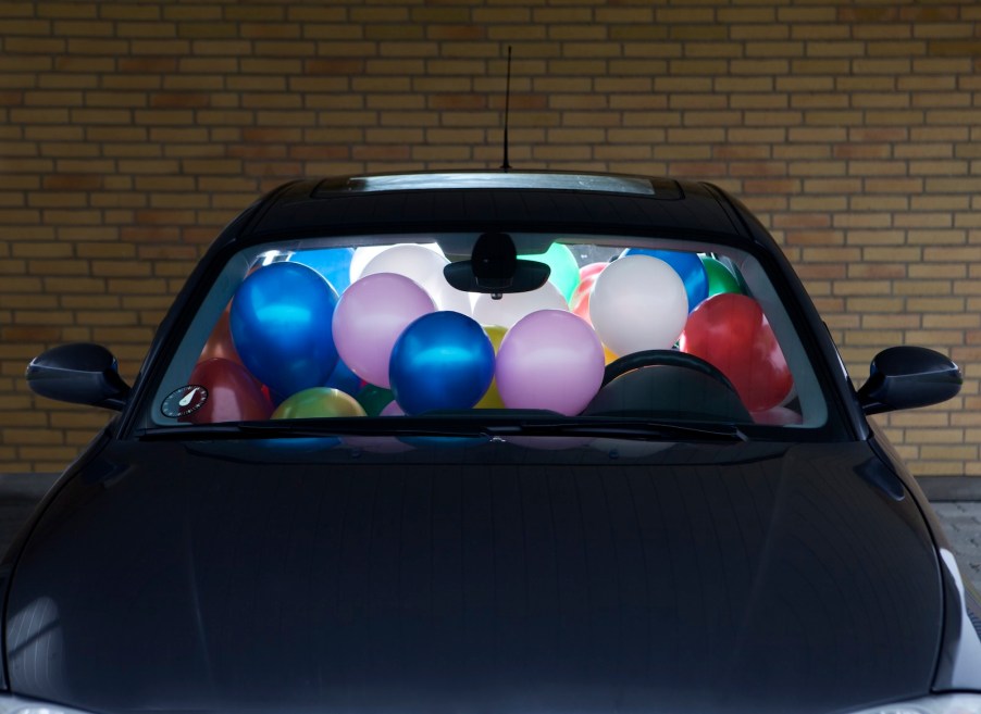 A car filled with balloons stopped by police for being unsafe.