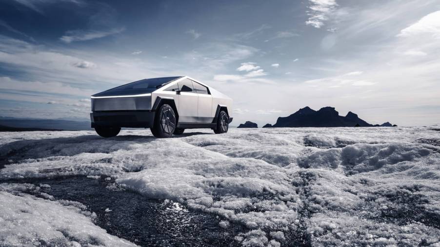A Tesla Cybertruck parked in the snow and ice.