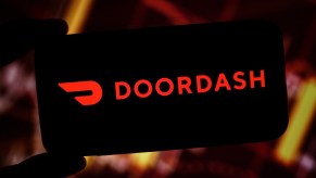 The DoorDash logo on a phone