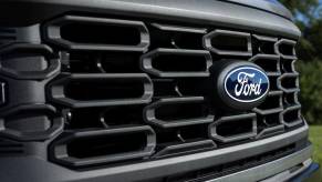 A Ford F-150 grille with a badge on it