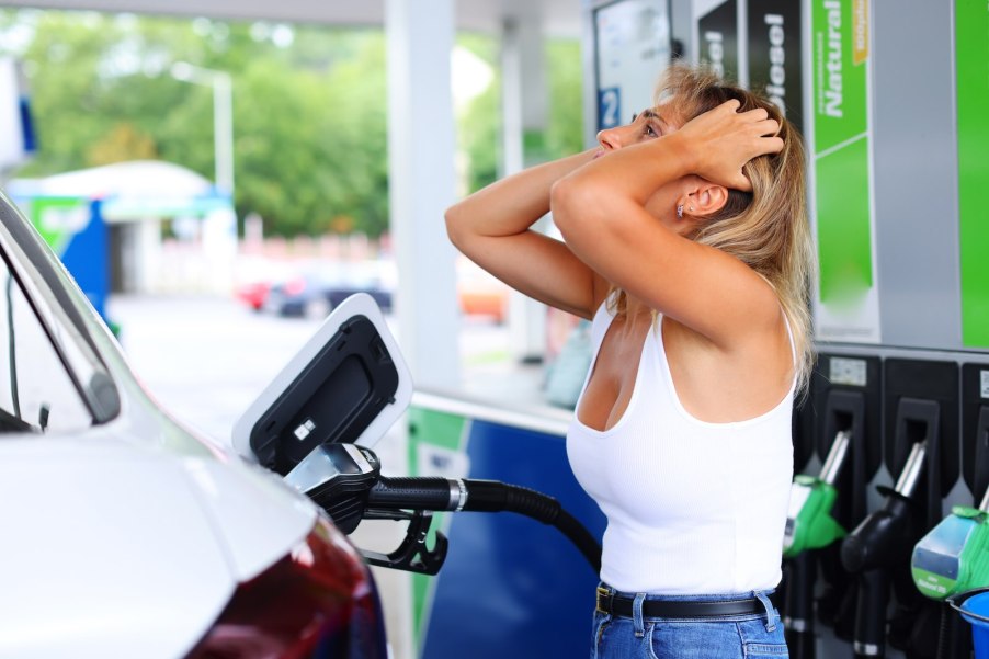 Woman at gasoline station frustrated by diesel fuel mixup.